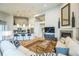 Open-concept living area with hardwood floors, fireplace, vaulted ceiling, and kitchen with an island and bar seating at 1261 W 170Th Ave, Broomfield, CO 80023