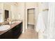 Bathroom with double sinks, ample counter space, and a shower-tub combination for a spa-like experience at 5562 W 72Nd Pl, Westminster, CO 80003