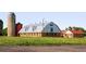 Picturesque view of the exteriors buildings with a silo on a farm with well-maintained lawn at 5562 W 72Nd Pl, Westminster, CO 80003