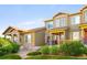 Inviting townhome exterior featuring well-maintained landscaping and a cozy front porch at 5562 W 72Nd Pl, Westminster, CO 80003