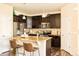 Modern kitchen with dark wood cabinets, granite countertops, and stainless steel appliances at 5562 W 72Nd Pl, Westminster, CO 80003