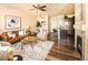 Open-concept living space with modern furniture, a kitchen island, and a cozy fireplace at 5562 W 72Nd Pl, Westminster, CO 80003