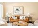 Cozy living room featuring a leather sofa, stylish decor, and ample natural light at 5562 W 72Nd Pl, Westminster, CO 80003