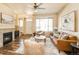 Bright living room with a fireplace, large window, and stylish furniture arrangement at 5562 W 72Nd Pl, Westminster, CO 80003