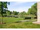 Scenic view of a pond with a bridge, benches, and mature trees, offering a tranquil space at 5562 W 72Nd Pl, Westminster, CO 80003
