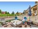 Backyard patio featuring a seating area, lush lawn, and views of the surrounding neighborhood at 3668 Pecos Trl, Castle Rock, CO 80109