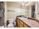 Clean bathroom featuring a shower with decorative tiles, a toilet, and sink with ample counter space at 3668 Pecos Trl, Castle Rock, CO 80109