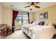 Inviting bedroom with a ceiling fan, large window, and soft carpet flooring at 3668 Pecos Trl, Castle Rock, CO 80109