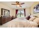 Bright and airy bedroom features a large window, ceiling fan, and a spacious closet at 3668 Pecos Trl, Castle Rock, CO 80109
