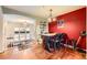 Dining room with wood floors and decorative chandelier is adjacent to a living room with an archway and staircase at 3668 Pecos Trl, Castle Rock, CO 80109
