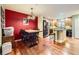 Bright dining area featuring hardwood floors, decorative chandelier, and easy access to the kitchen and stainless steel appliances at 3668 Pecos Trl, Castle Rock, CO 80109
