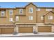 Home exterior featuring garage doors, brown siding, and a stone facade at 3668 Pecos Trl, Castle Rock, CO 80109