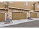 Home exterior featuring garage doors and a stone facade at 3668 Pecos Trl, Castle Rock, CO 80109