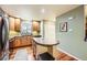 Charming kitchen featuring wood cabinets, stainless steel appliances, granite countertops, and an eat in island at 3668 Pecos Trl, Castle Rock, CO 80109