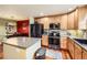 Well-equipped kitchen with stainless steel appliances, an island with granite countertops, and adjacent access to the dining area at 3668 Pecos Trl, Castle Rock, CO 80109