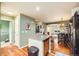 Open concept kitchen featuring an island and is adjacent to the dining area and staircase to the upper level at 3668 Pecos Trl, Castle Rock, CO 80109