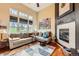 Bright living room with large windows, a comfortable sectional sofa, and a modern fireplace at 3668 Pecos Trl, Castle Rock, CO 80109