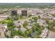 A picturesque aerial view of a pond surrounded by residences, trees, and commercial buildings in the distance at 2840 S Kenton Ct, Aurora, CO 80014