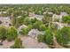 An aerial view showcasing a residential community nestled amongst green trees and pathways at 2840 S Kenton Ct, Aurora, CO 80014