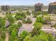 An aerial view of a building surrounded by lush greenery, pond, and other buildings at 2840 S Kenton Ct, Aurora, CO 80014