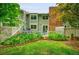 Green backyard with manicured garden beds and a white picket fence for privacy at 2840 S Kenton Ct, Aurora, CO 80014