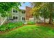Green backyard with manicured garden beds and a white picket fence for privacy at 2840 S Kenton Ct, Aurora, CO 80014