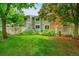 Green backyard with manicured garden beds and a white picket fence for privacy at 2840 S Kenton Ct, Aurora, CO 80014