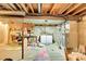 Unfinished basement with laundry hookups, exposed ceiling, and storage potential at 2840 S Kenton Ct, Aurora, CO 80014
