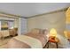 Bedroom features a bed, side table with lamp, closet and shelving for ample storage at 2840 S Kenton Ct, Aurora, CO 80014