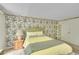 Bright bedroom featuring decorative wall paper and a comfy bed at 2840 S Kenton Ct, Aurora, CO 80014
