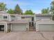 Charming townhome exterior with a two-car garage, and beautifully landscaped front entrance at 2840 S Kenton Ct, Aurora, CO 80014