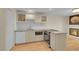 Well-lit kitchen with stainless appliances, light cabinetry, and hardwood floors at 2840 S Kenton Ct, Aurora, CO 80014