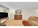 Comfortable living room with a TV, hardwood floors, and classic wooden furniture at 2840 S Kenton Ct, Aurora, CO 80014