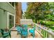 Back patio featuring a table and chairs, surrounded by a white fence and landscaping at 2840 S Kenton Ct, Aurora, CO 80014