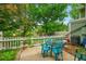 Back patio featuring a table and chairs with a view of a pond and lush landscaping at 2840 S Kenton Ct, Aurora, CO 80014