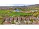 Aerial view of homes in a suburban neighborhood, showing yards, landscaping, and surrounding green space at 15960 W 62Nd Dr, Arvada, CO 80403