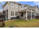 Large backyard with lush green grass, patio, swing, and fence with view of the home's exterior at 15960 W 62Nd Dr, Arvada, CO 80403