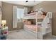 Cozy bedroom with stylish bunk beds with stairs, soft carpet, and a window providing natural light at 15960 W 62Nd Dr, Arvada, CO 80403