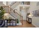 Welcoming entryway featuring a staircase with dark metal spindles, decor, and wood flooring at 15960 W 62Nd Dr, Arvada, CO 80403