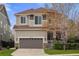 Charming two-story home with a well maintained lawn, covered front porch, and a large two-car garage at 15960 W 62Nd Dr, Arvada, CO 80403