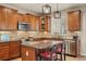 Modern kitchen boasts stainless steel appliances, tiled backsplash, and an island with bar seating at 15960 W 62Nd Dr, Arvada, CO 80403