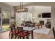 Open concept living room with a fireplace, wood floors, and dining area with glass sliding door at 15960 W 62Nd Dr, Arvada, CO 80403
