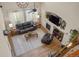 Bright living room featuring a fireplace, large windows, a ceiling fan and comfortable seating at 15960 W 62Nd Dr, Arvada, CO 80403
