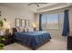 Cozy main bedroom with tray ceiling, ample natural light, and comfortable king-sized bed at 15960 W 62Nd Dr, Arvada, CO 80403