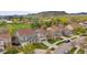 Street view of homes with attached garages, manicured lawns, and mountain views in the distance at 15960 W 62Nd Dr, Arvada, CO 80403