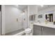 Modern bathroom with a glass shower, gray cabinets, and gold accents at 1781 Chestnut Ave, Erie, CO 80516