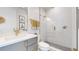 Clean bathroom with a walk-in shower, gray vanity, and gold fixtures at 1781 Chestnut Ave, Erie, CO 80516