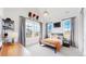 Bright bedroom with large windows, a comfortable bed, and basketball decor at 1781 Chestnut Ave, Erie, CO 80516