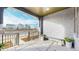 Covered front porch with a metal bench and planters, offering curb appeal at 1781 Chestnut Ave, Erie, CO 80516