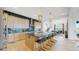 Open concept kitchen with island and views into the dining and living areas at 1781 Chestnut Ave, Erie, CO 80516